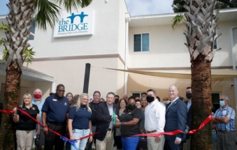 City and county officials along with staff and volunteers cut the ribbon on the Bridge in DeLand, Saturday, Sept. 18, 2021.